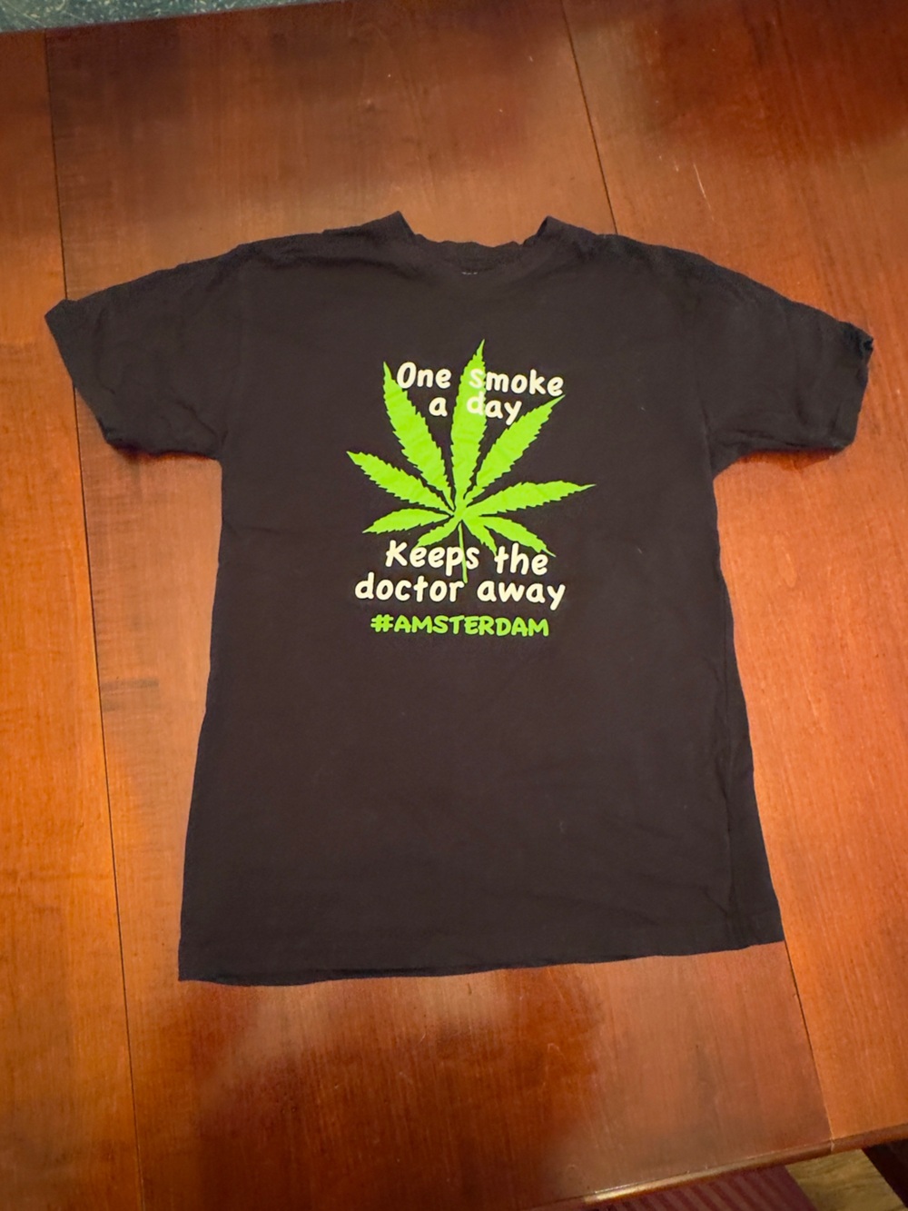 Black Short-Sleeve Graphic Tee with Green Leaf Print